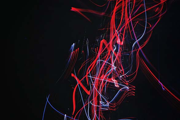 an abstract picture with read blue and white lines on a black background.